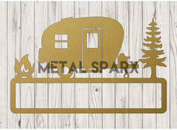 Gold metal art camper custom name plaque with personalized lettering, crafted by Metal Sparx for outdoor decor or wall display.