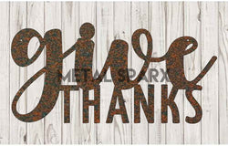 Rust-colored metal "Give Thanks" sign by Metal Sparx with decorative leaf accents, perfect for seasonal autumn decor.